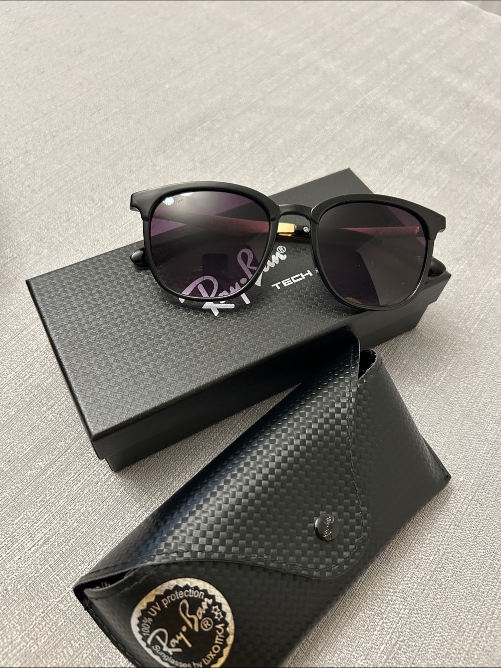 Ray-Ban Black Frame Sunglasses with Purple-Tinted Lenses